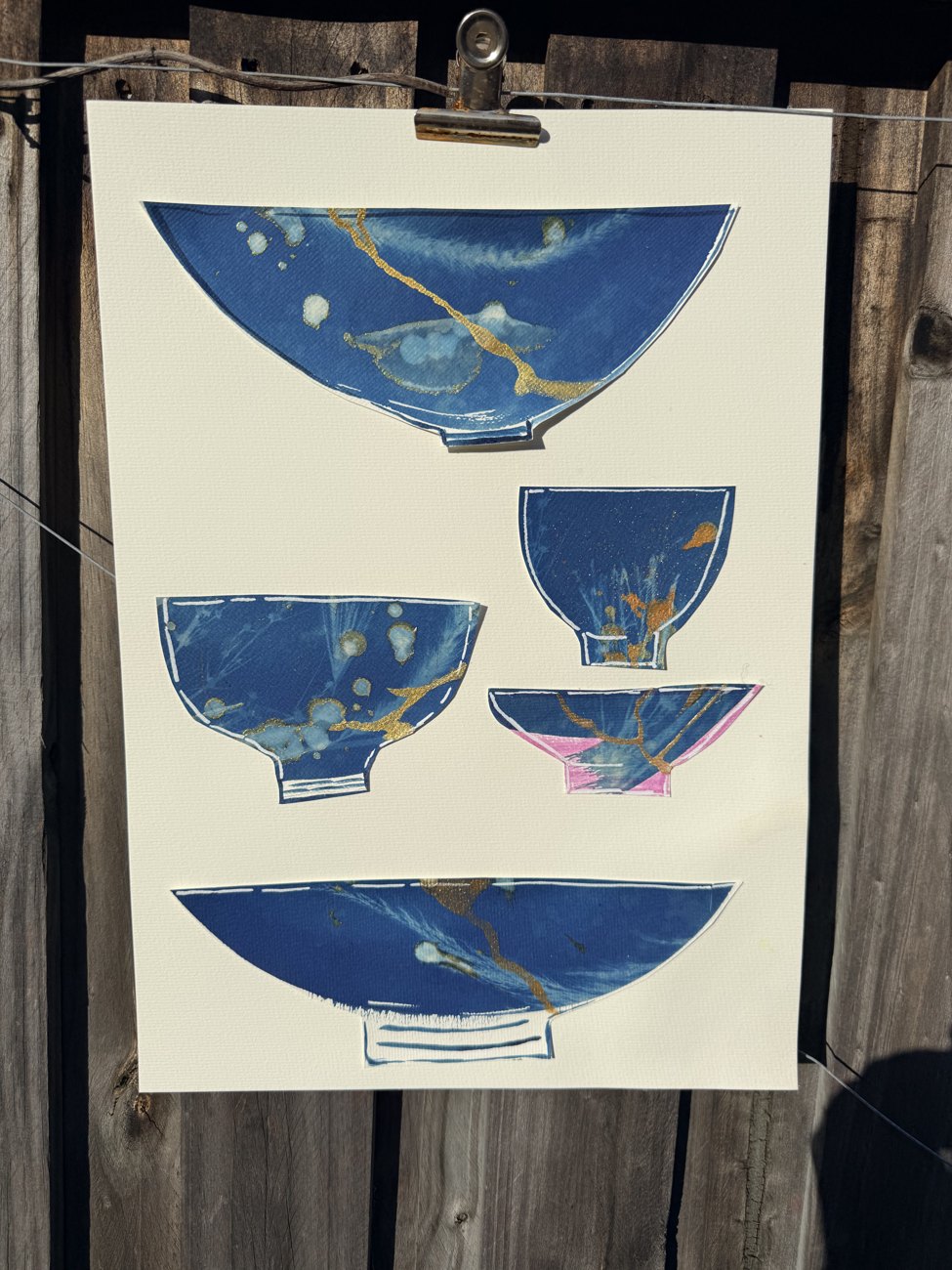 A cyanotype of deep-blue bowls on a cream ground, arranged in a quiet rhythm